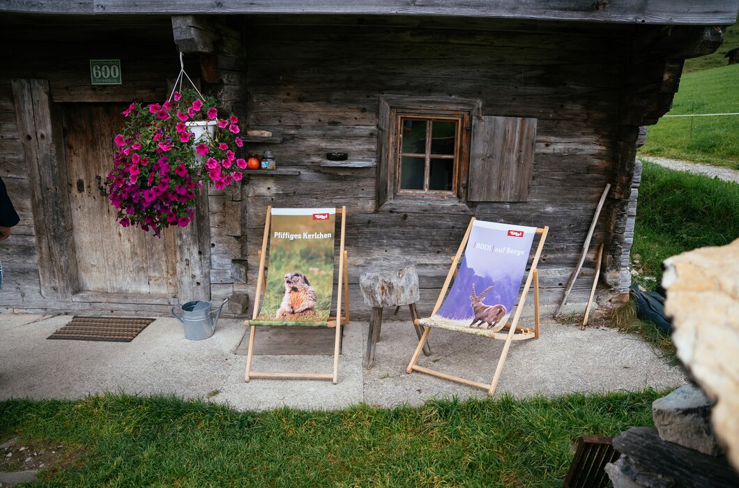 Hütte von außen mit Blumen und Liegestühlen | © Urlaub am Bauernhof Tirol / Daniel Gollner 