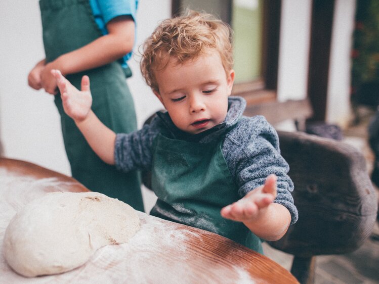 Bub hat beim Brotbacken mehlige Hände | © Urlaub am Bauernhof Kärnten / Daniel Gollner