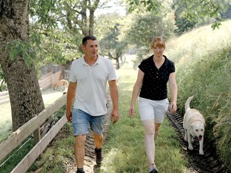 Frau und Mann bei einem Spaziergang im Sommer auf einem Feldweg | © Urlaub am Bauernhof Kärnten / Daniel Gollner