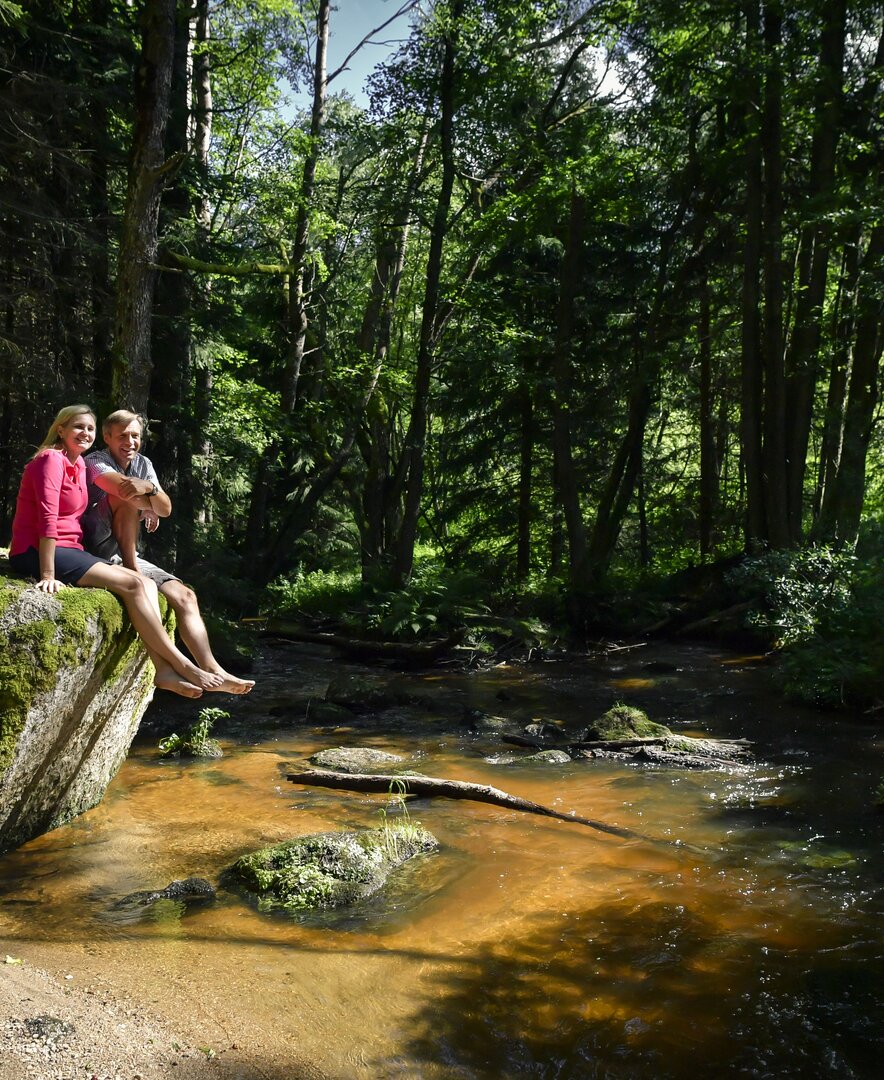 Paar sitzt auf Stein bei einem Flussbett im Waldviertel | © Waldviertel Tourismus / Robert Herbst