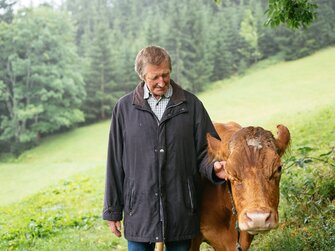 Der Gastgeber vom Bauernhof Morgenbesser bei den Kühen | © Daniel Gollner / Urlaub am Bauernhof